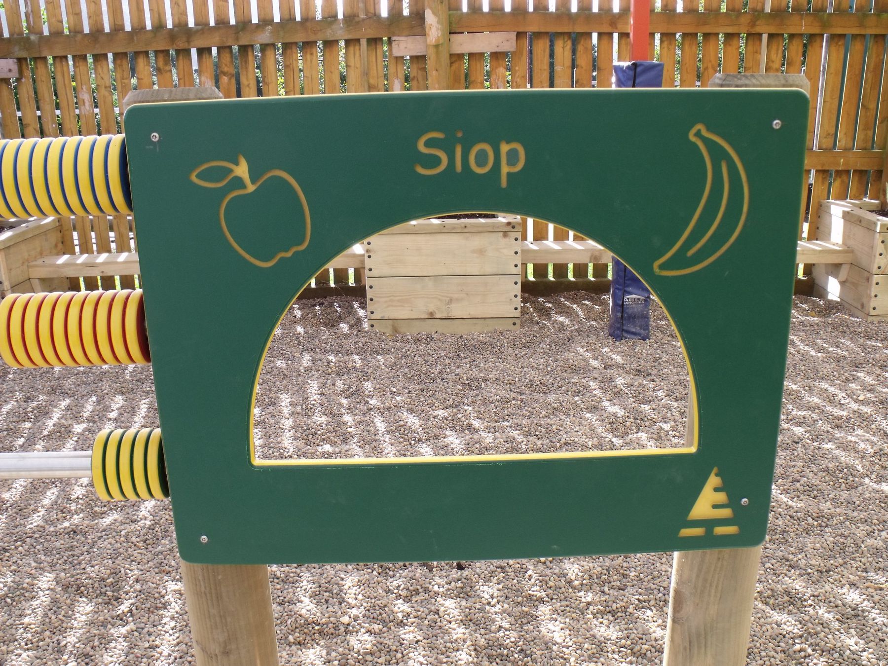 Green timber play panel carved Siop, with a serving window