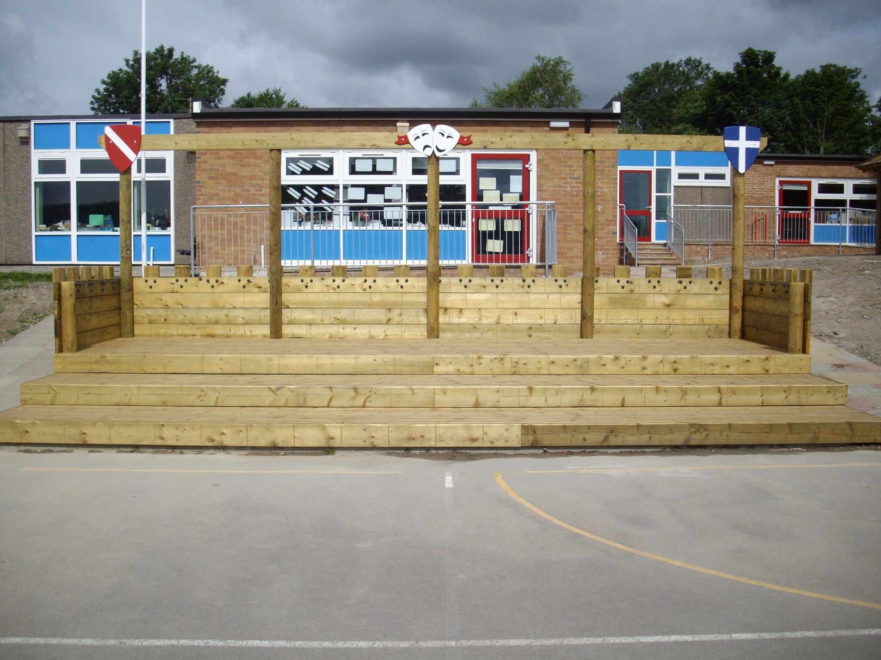 Large tiered timber stage built across the front of a school playground