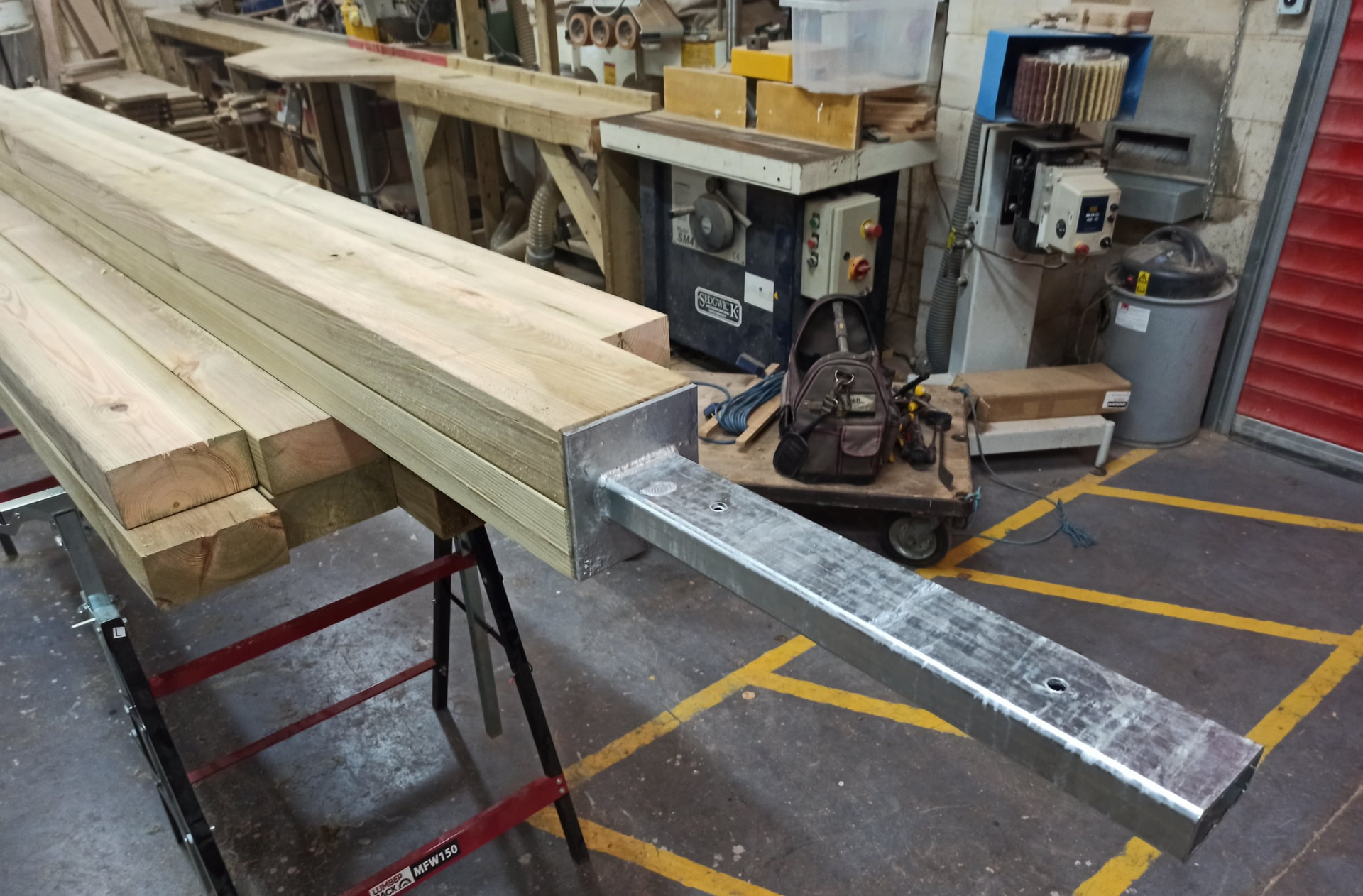 Galvanised steel post shoe fixed to the end of a timber post in the Craft Wales workshop