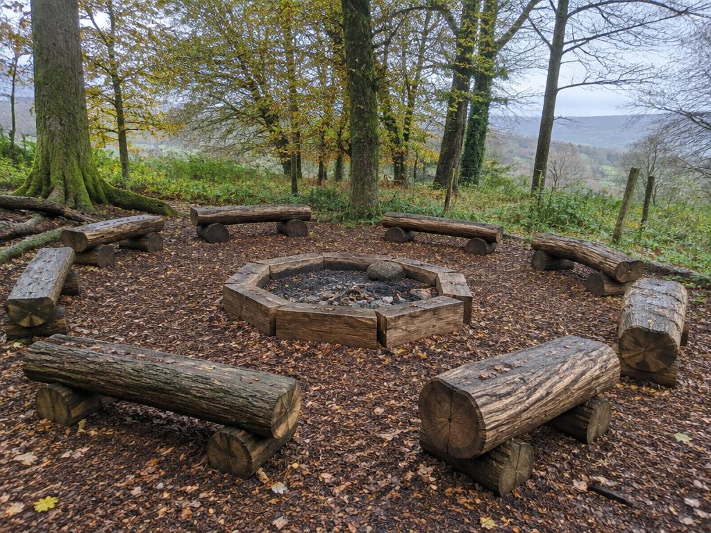 Illustrative log-seated fire circle for Forest School sessions in a Welsh school woodland