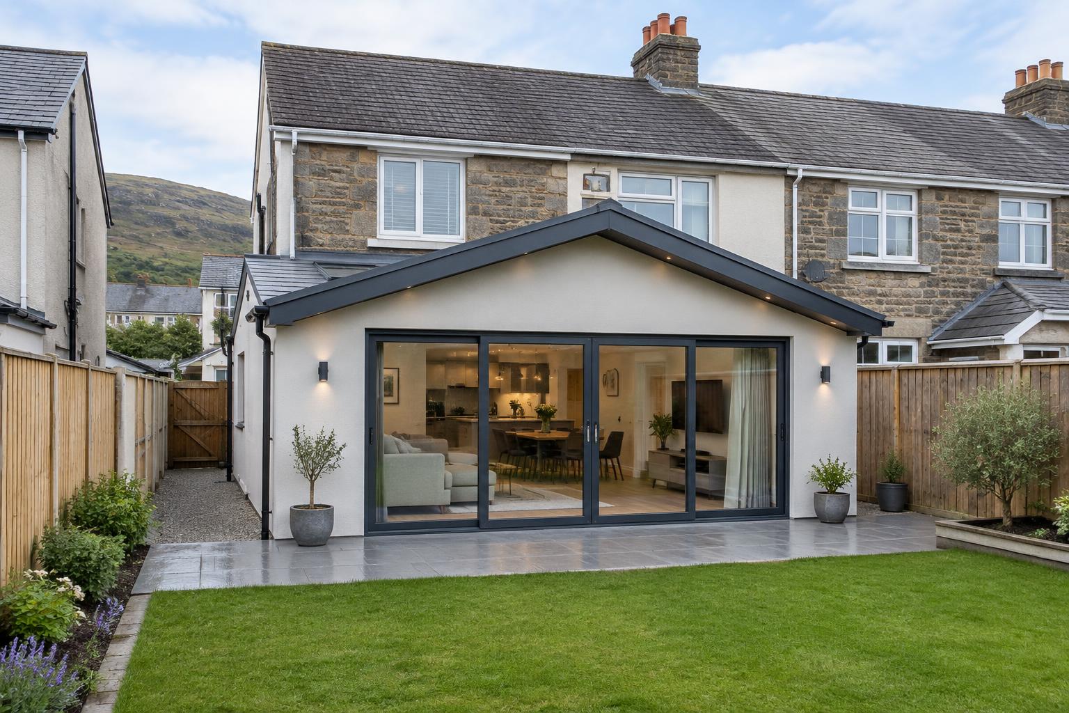 Illustrative house extension with glass doors opening onto a garden in South Wales